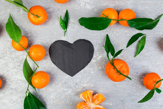 Tangerine around with black slate heart shaped.