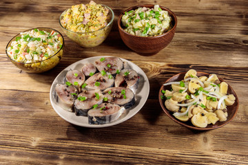 Various festive dishes on wooden table