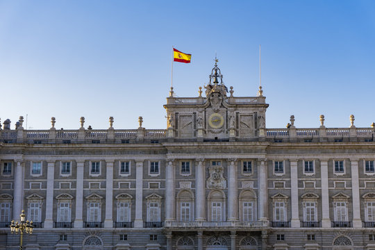 Madrid, Spain Royal Palace facade with Spanish flag waving.
External view of Palacio Real de Madrid in the Spanish capital, the official residence of the Spanish Royal Family.