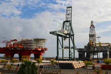 Oil drilling and support platforms and crane in industrial sea port