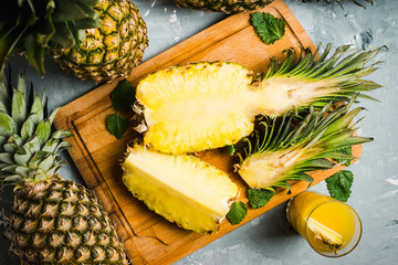Fresh ripe pineapples on the rustic background. Selective focus. - obrazy, fototapety, plakaty