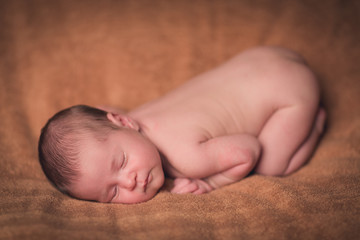 beautiful sweet newborn baby sleeping on a blanket