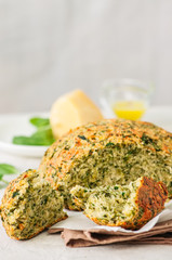 Freshly baked cheesy spinach bread on a white stone backdrop. Rustic style.