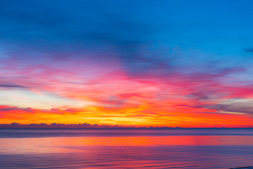 Naklejka na ściany i meble colorful sunset with calm sea and colorful clouds, seascape