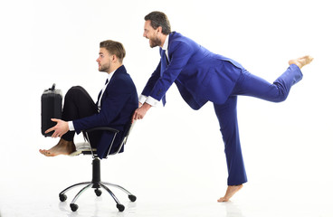 Business people have fun and ride on office chair.