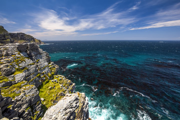 Beautiful ocean view at the Cape Of Good Hope at the southern tip of Cape Peninsula near Cape Town, South Africa. Beautiful mountain range and clear Atlantic Ocean water. Famous tourist destination.