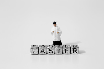 Miniature scale model priest with Easter on beads