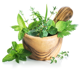 Different fresh green herbs in the wooden mortar. - Powered by Adobe