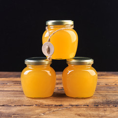 jar of honey at wooden background