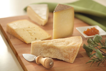 mixed cheese on a wood breadboard