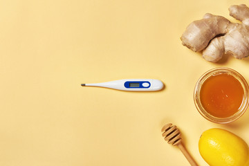 Fresh ginger root, lemon, honey and thermometer