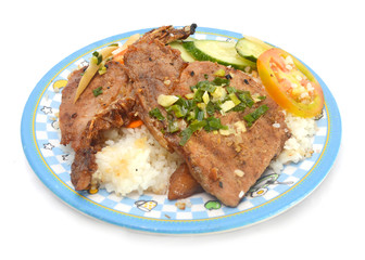 Closeup of vietnamese food: steamed rice dish with meat pie and BBQ pork chop