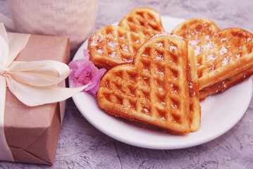 Heart Shaped Waffles for Breakfast with Gift Box on table with Little Pink flower, View from above
