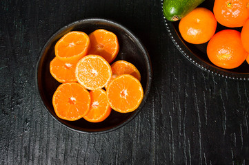 Sliced tangerine in a bowl top view