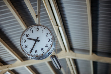 clock in the train station on background.