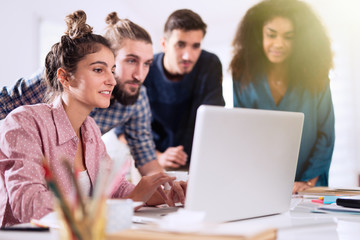 Young multiethnic creative team sharing ideas on a project 