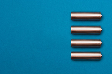 recycling, energy, power, environment and ecology concept - close up of green alkaline batteries