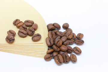 Bean and powder coffee with paper for coffee drip. Cone-type coffee filter for pour over coffee, made of unbleached paper