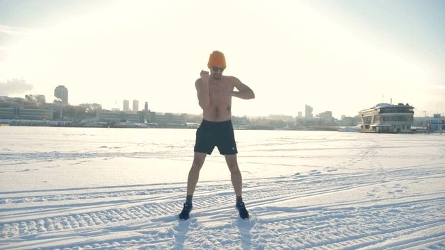 An athlete jumps and stretches before a run on the snow. 