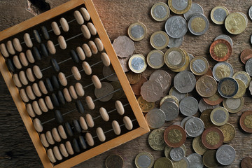 a bunch of different coins and wooden abacus