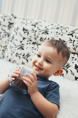 the child at home in a cozy atmosphere drinking hot chocolate