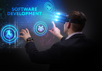 Business, Technology, Internet and network concept. Young businessman working on a virtual screen of the future and sees the inscription: Software development