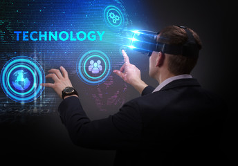 Business, Technology, Internet and network concept. Young businessman working on a virtual screen of the future and sees the inscription: Technology
