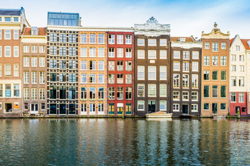 Naklejka premium Canal houses of Amsterdam, Netherlands. Traditional old buildings in Amsterdam