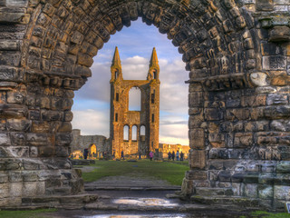 The sun shining on the ruins of St Andrews Cathedral viewed through the archway