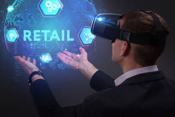 Business, Technology, Internet and network concept. Young businessman working on a virtual screen of the future and sees the inscription: Retail