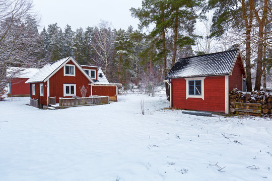 Winter Scenery With Red Wooden House In Sweden