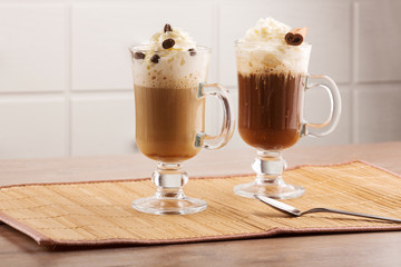Two coffee cocktails decorated with cream and spicy spices on a napkin