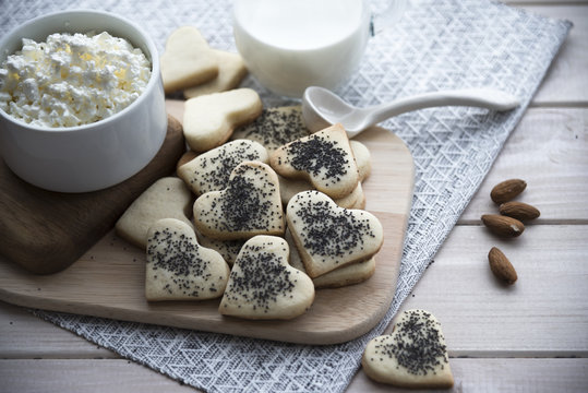homemade cookies with poppy seeds, milk, cottage cheese and nuts. Breakfast