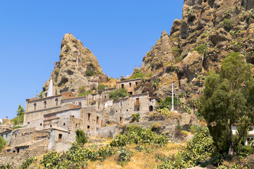 Fototapeta premium Panorama of an ancient and abandoned village nestled among the arid rocks and wild nature Pentedattilo (calabria)
