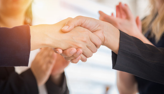 Business people shaking hands after finish reach agreement for startup new project. Negotiating and Happy working concept. Handshake gesturing connection deal concept. People and teamwork theme