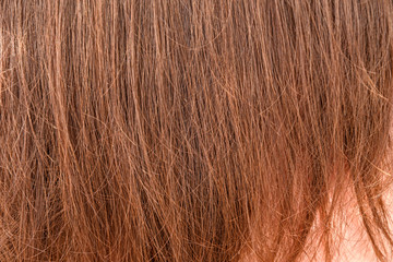 Natural colored shiny healthy human hair with fluff ends. Haircare technology, style and beauty concept. Abstract texture background. Detailed closeup