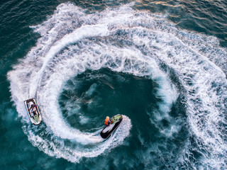 People are playing a jet ski in the sea.Aerial view. Top view.amazing nature background.The color...
