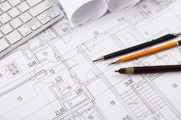 Architectural project, engineering tools on table.