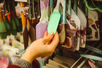 woman choose silicone kitchen spatula