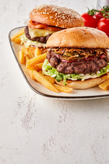 Gourmet beef burgers one with cheese one with ham