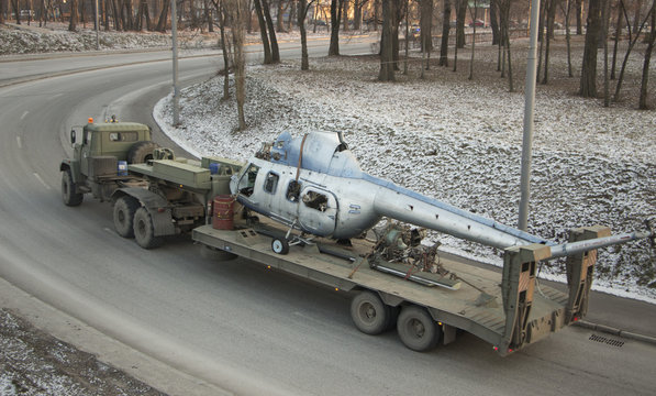 A Soviet-made military truck is transported by a broken helicopter