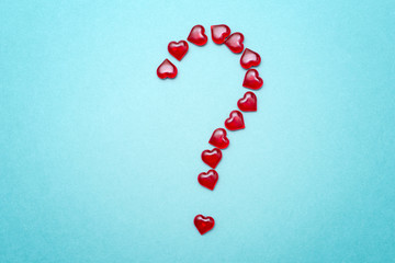the question mark in the form of red hearts on a blue background