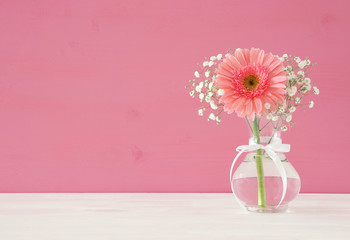 summer bouquet of flowers in the vase over the wooden table.