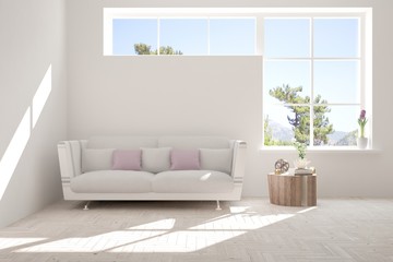 Fototapeta premium Idea of white room with sofa and summer landscape in window. Scandinavian interior design. 3D illustration