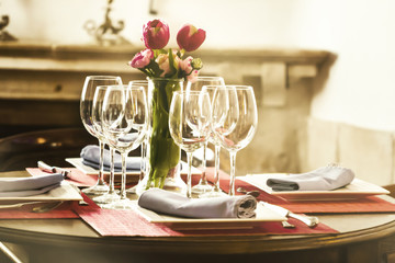 Soft focus vintage tone, Empty glass and flowers on the table in restaurant with blurred  background.