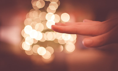 Fototapeta premium hand with golden bokeh sparkles