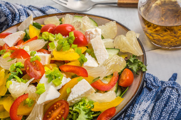 Salad with cheese and fresh vegetables.