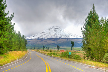 Naklejka premium View of the Cotopaxi volcano, from the entrance to the Cotopaxi National Park, on an overcast day.
