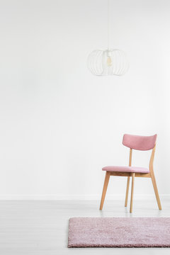Pink chair in white interior