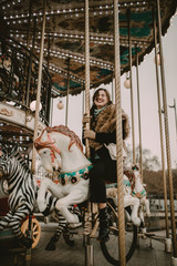 Fototapeta na wymiar Young woman in the carousel of Paris